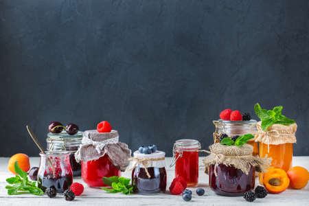 Food and drink, harvest summer autumn concept. Assortment of seasonal berries and fruits jams in...