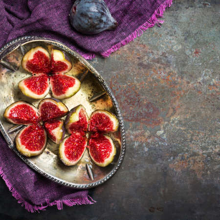 Autumn fall harvest concept. Ripe juicy violet figs on a dark rusty kitchen table. Top view flat lay copy space backgroundの写真素材