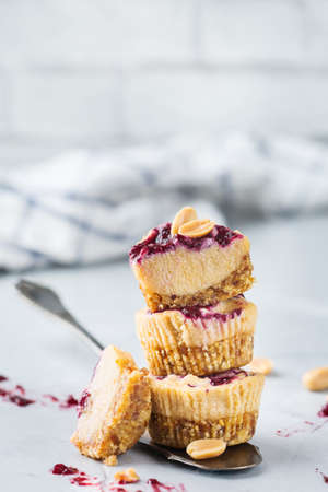 Food and drink, healthy lifestyle, eating, diet and nutrition, snack, superfood concept. Handmade no bake raw vegan protein energy peanut butter bars or cheesecakes on a kitchen tableの写真素材