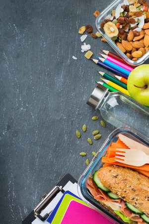 Food and drink, still life, diet and nutrition, healthy eating, take away concept. School lunch box and stationery. Top view flat lay, copy space chalkboard backgroundの写真素材