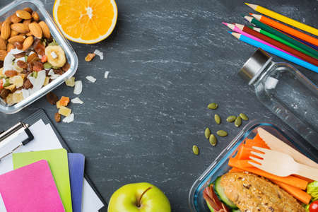 Food and drink, still life, diet and nutrition, healthy eating, take away concept. School lunch box and stationery. Top view flat lay, copy space chalkboard backgroundの写真素材