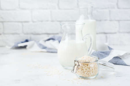 Food and drink, health care, diet and nutrition concept. Homemade organic vegan non diary rice milk on a kitchen table. Copy space backgroundの写真素材