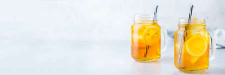 Food and drink, holidays party concept. Lemon mint iced tea cocktail refreshing drink beverage in a mason jar on a table for summer days. Copy space backgroundの写真素材