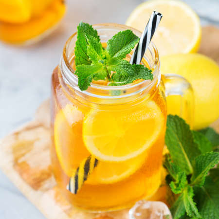 Food and drink, holidays party concept. Lemon mint iced tea cocktail refreshing drink beverage in a mason jar on a table for summer daysの写真素材