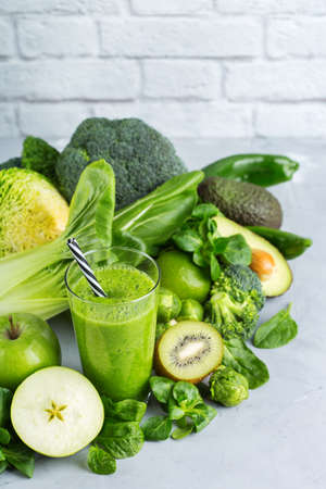 Food and drink, healthy dieting and nutrition, lifestyle, vegan, alkaline, vegetarian concept. Green smoothie with organic ingredients, vegetables on a modern kitchen tableの写真素材