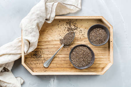 Healthy eating, dieting and nutrition, vegan concept. Organic chia seeds in a bowl, ingredient, superfood. Flat lay top view backgroundの写真素材