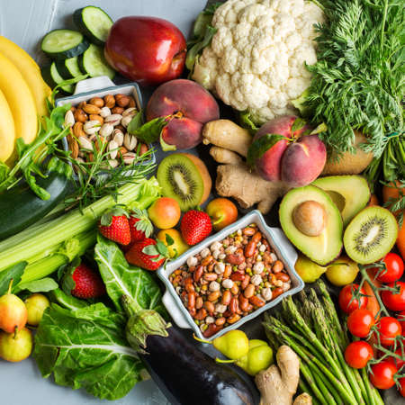 Balanced nutrition concept for clean eating alkaline diet. Assortment of healthy food ingredients for cooking on a kitchen table. Top view flat lay backgroundの写真素材
