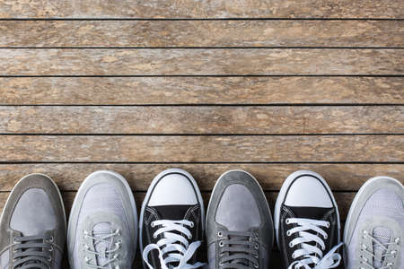Fashion, blog, blogging, lifestyle, well-being trendy concept. Set of male shoes, sneakers on wooden...