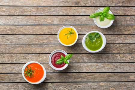 Healthy food, clean eating concept. Variety of colorful seasonal fall vegetables creamy soups with...
