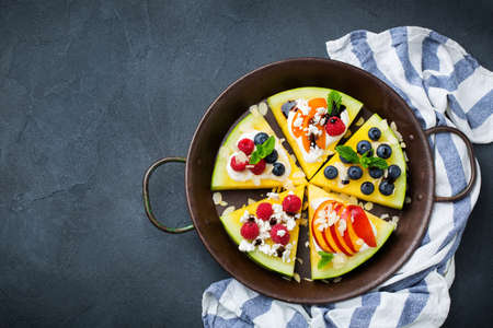 Healthy clean eating, dieting and nutrition, seasonal, summer concept. Watermelon pizza with berries, fruits, yogurt, feta cheese on a table. Top view flat lay copy space background.の写真素材