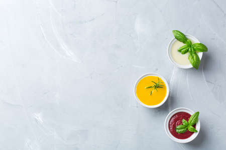 Healthy food, clean eating concept. Variety of colorful seasonal fall vegetables creamy soups with...