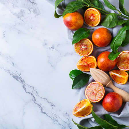 Vitamin, clean eating, healthy food vegan concept. Whole and sliced sweet sicilian blood oranges on...
