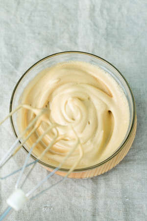 Trendy Dalgona Coffee drink, home preparation. Iced frothy whipped ultra fluffy texture. Viral social media worthy drink in coronavirus, Covid-19, lockdown, quarantine, stay at home.の写真素材