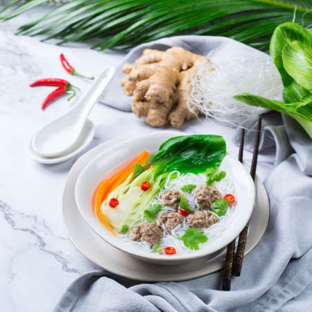 Food and drink, traditional asian cuisine. Spicy bee hoon, bihun soup with pork meat balls and rice...