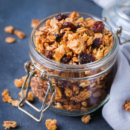 Healthy clean eating, dieting and nutrition, fitness, balanced food, breakfast concept. Homemade granola muesli with ingredients on a tableの写真素材