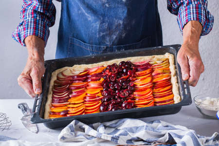 Baking, eating at home, healthy food and lifestyle concept. Senior baker man cooking, kneading fresh...