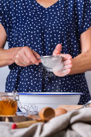 Happy senior mature woman, grandmother cooking, kneading dough, baking pie, cake,  cookies. Autumn...