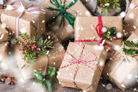 Creative zero waste Christmas concept. Gift boxes with handmade eco friendly craft wrapping paper and traditional Japanese style furoshiki fabric packaging.の写真素材