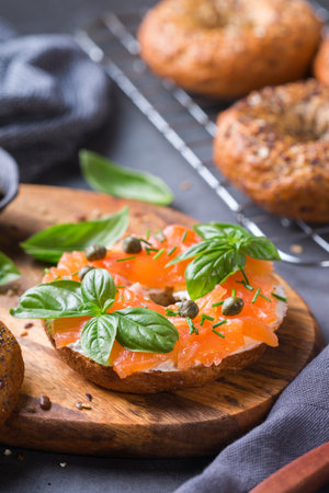 Food, lunch, brunch, meal on a plate, plating concept. Bagels with smoked salmon, cream cheese and capers on a table.の写真素材