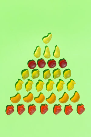 Jelly fruit candies, sweets on a mint green background with shadows. Arts and crafts, creative artwork, diy, fun selftime, education, learning conceptの写真素材