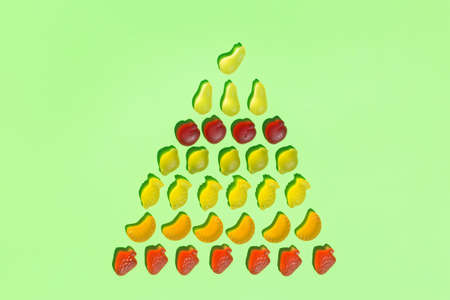 Jelly fruit candies, sweets on a mint green background with shadows. Arts and crafts, creative artwork, diy, fun selftime, education, learning conceptの写真素材