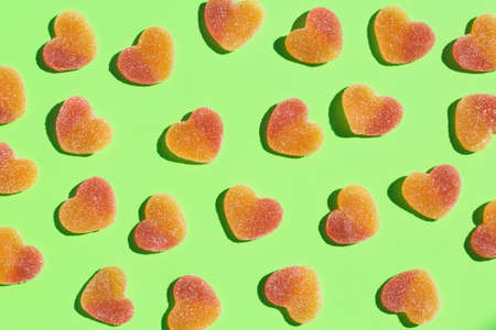 Jelly heart shaped candies, sweets on a mint green background with shadows. Arts and crafts, creative artwork, diy, fun selftime, education, learning conceptの写真素材