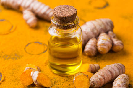 Turmeric essential oil, orange root and powder, beauty and spa