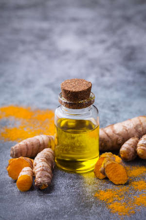 Turmeric essential oil, orange root and powder, beauty and spaの写真素材