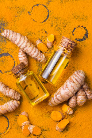 Turmeric essential oil, orange root and powder, beauty and spaの写真素材