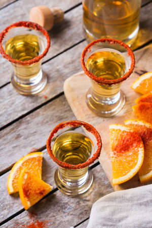 Mexican mezcal or mescal shot with chili pepper and orangeの写真素材