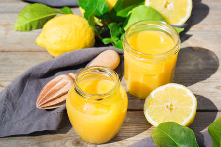 Homemade lemon curd, custard cream with yellow fruitsの写真素材