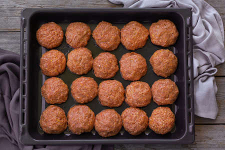 Raw beef and pork meat cutlets, cooking at home