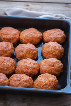 Raw beef and pork meat cutlets, cooking at home