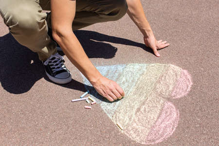 Man is drawing rainbow heart, symbol of lgbtの写真素材