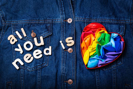 Heart shaped rainbow lgbtq flag against denim background, pride monthの写真素材