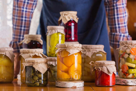Young man holding in hands preserved food