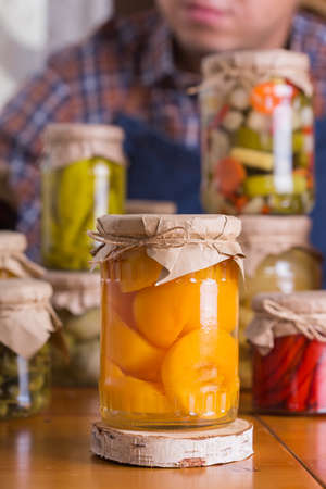 Young man holding in hands preserved foodの写真素材