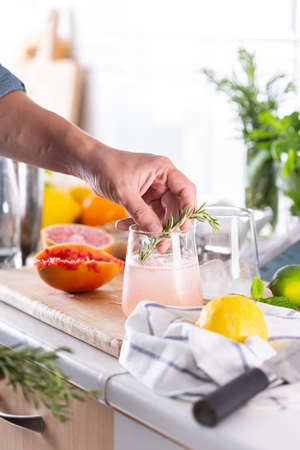 Mixologist making refreshing cocktail with hard seltzer at homeの写真素材