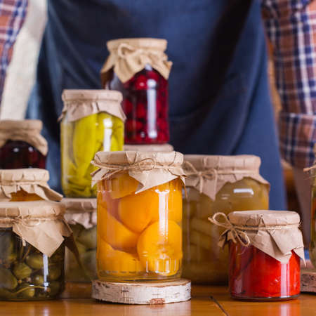Young man holding in hands preserved foodの写真素材