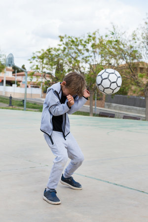 Stylish young boy, teenager is playing with ball, outdoorsの写真素材