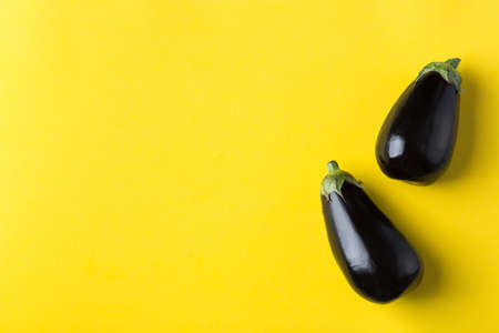 Eggplant or aubergine on yellow background, healthy eating conceptの写真素材