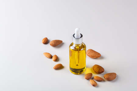 Almond essential oil in a bottle, wellbeing, wellness concept