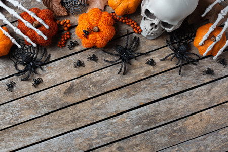 Halloween greeting card with pumpkin, skulls, bony hands and leavesの写真素材