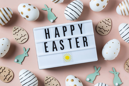 Happy Easter greeting card with eggs on pink backgroundの写真素材