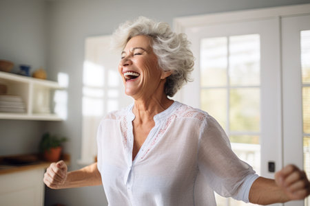 Caucasian middle aged mature woman dancing at homeの素材