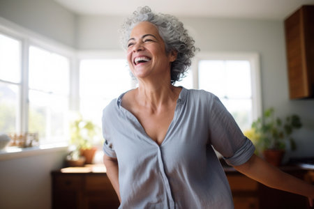 Hispanic middle aged mature woman dancing at homeの素材