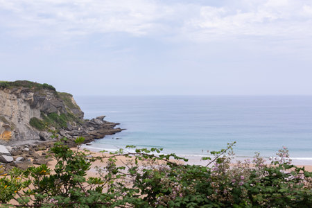 Rocky coastline and Playa de Matalenas beach near Santander, Cantabriaの写真素材