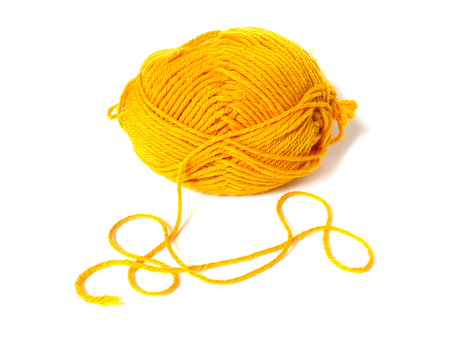 yellow ball of wool, on white backgroundの写真素材