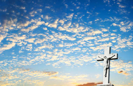 Background of Jesus Christ Crucifix with Clouds and Sunset in the Backgroundの写真素材