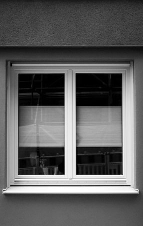 White plastic window on the wall of the house. Black and white.の写真素材